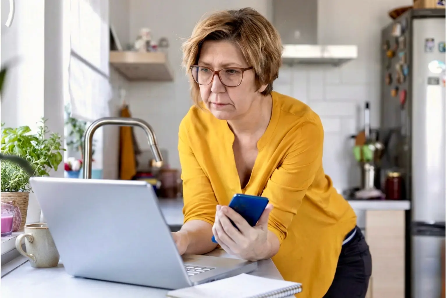 Middle-aged woman looking concerned while checking her laptop to compare her balance against the average retirement savings by age.