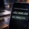 A close-up of a smartphone banking app screen showing a green "Pending" notification for a $2,000 direct deposit with the transaction code IRS TREAS 310