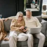 Middle-class couple reviewing finances at home, reflecting the comfort trap of feeling financially okay