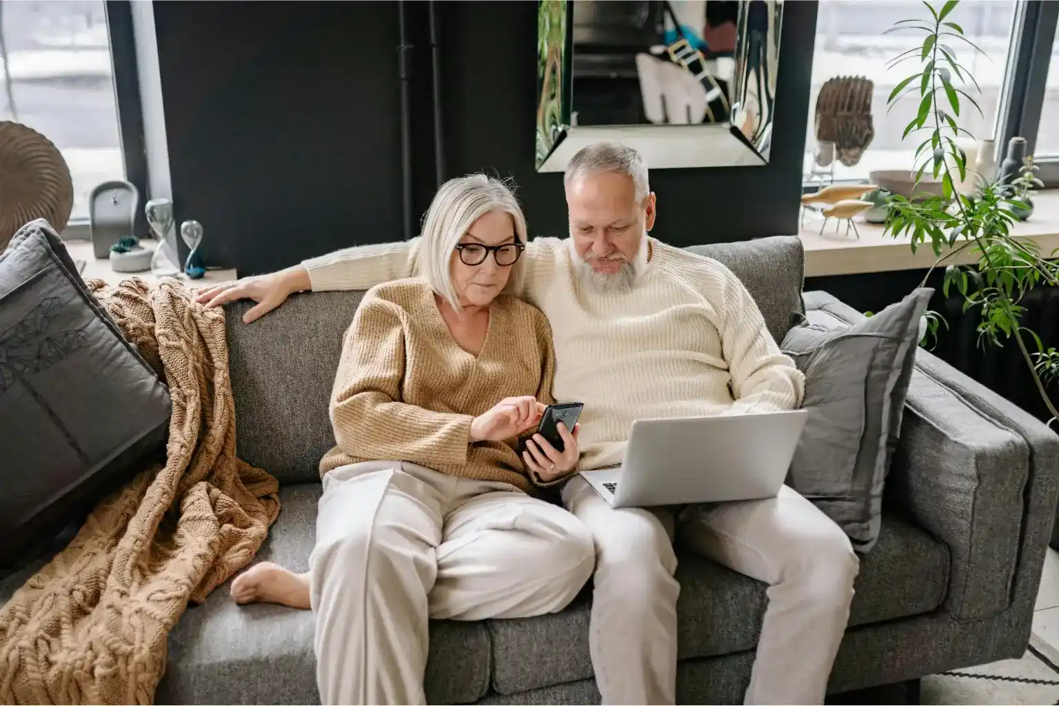 Middle-class couple reviewing finances at home, reflecting the comfort trap of feeling financially okay