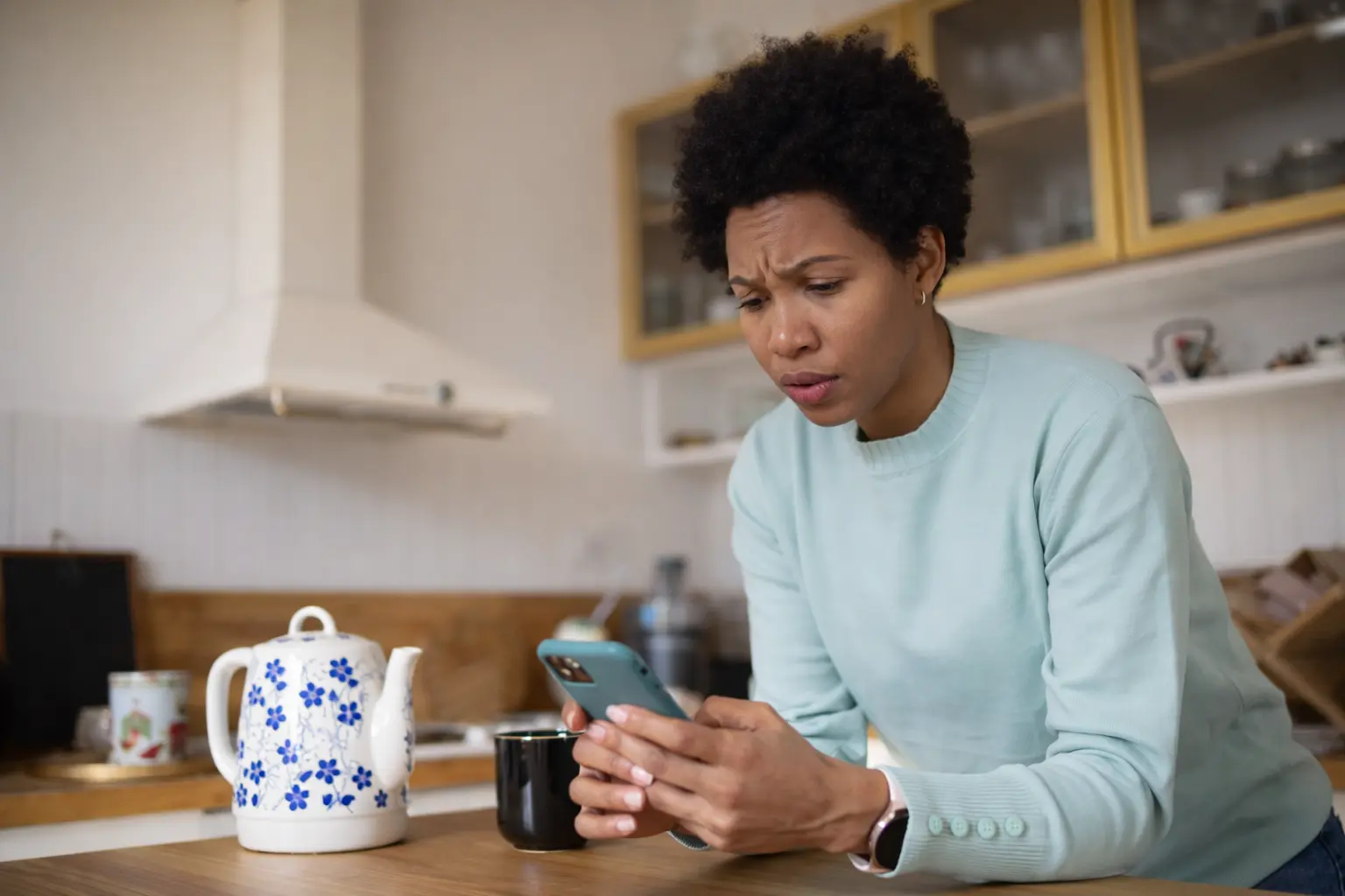 Woman checking bank app after confirmed deposit showing $0 balance in morning