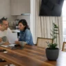 Stable household reviewing bills, illustrating financial fragility despite steady income