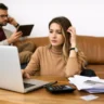 Middle-class woman reviewing household finances at home as the margin collapse narrows financial buffers
