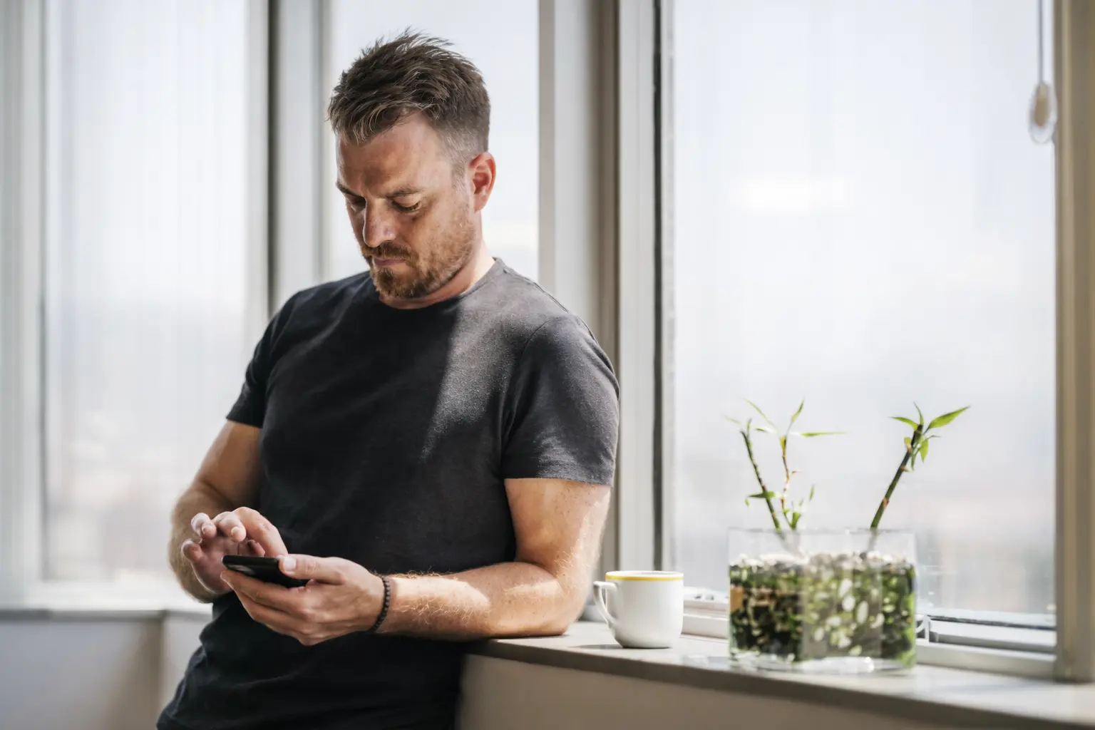 U.S. adult checking banking app after pending deposit balance not updated in early morning light