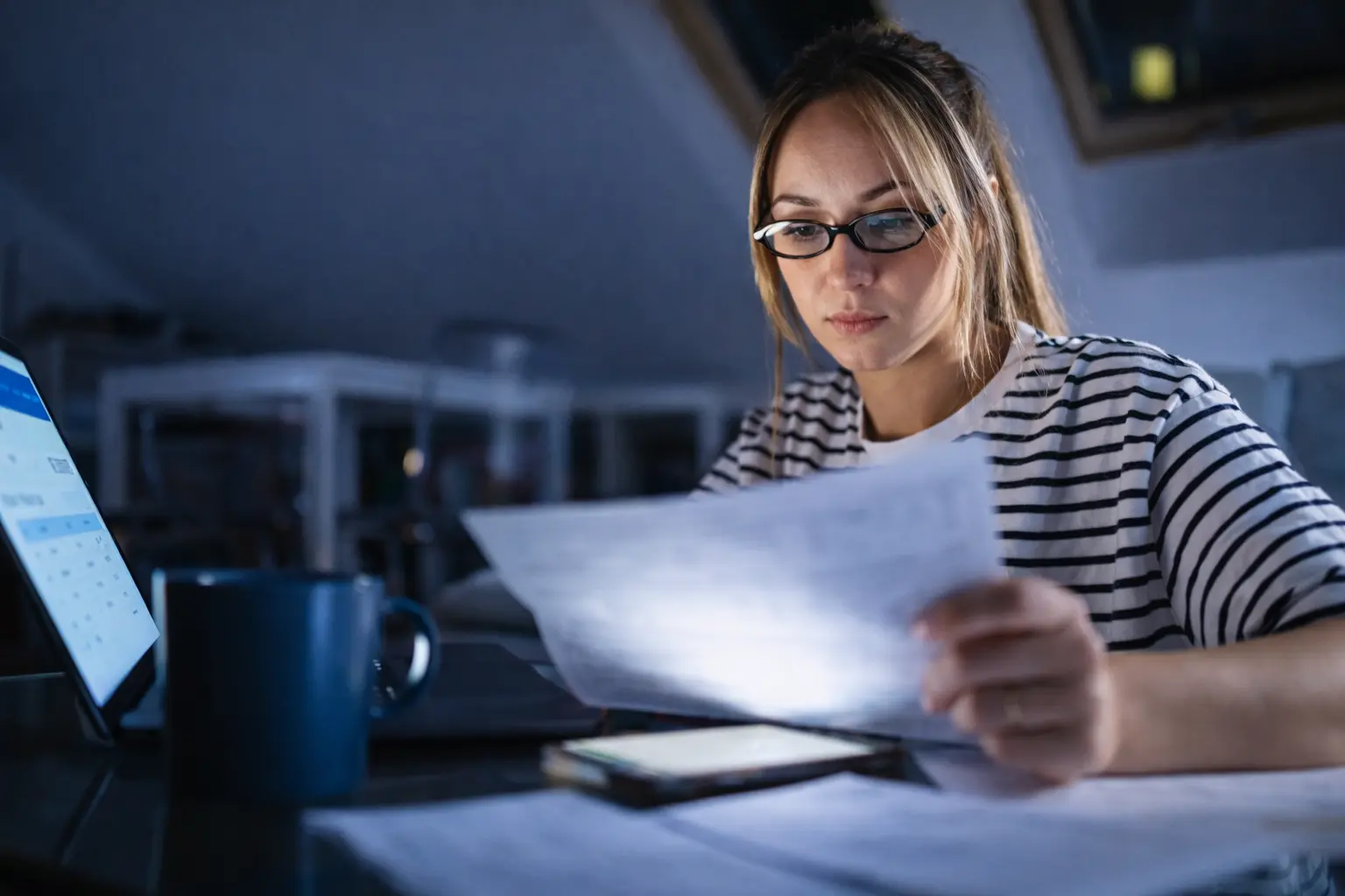 Woman checking phone as pending deposits appear in bank app during evening settlement processing