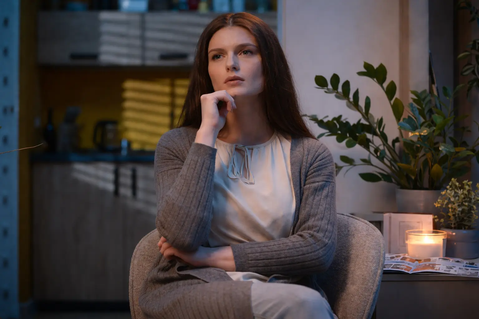 Woman sitting in a modern living room, reflecting on Upgrade Treadmill happiness despite lifestyle comfort
