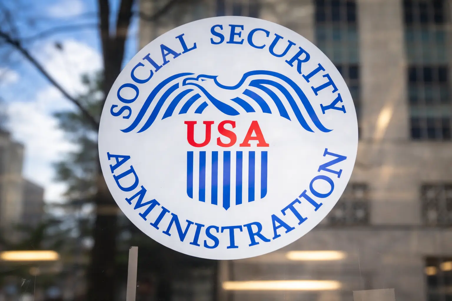 A calendar with March 11 and 18 circled next to a smartphone showing a Social Security payment status, explaining birth date timing shifts.