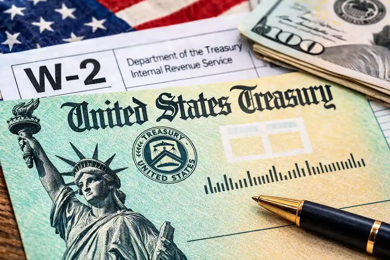 U.S. Treasury check with W-2 tax form representing people asking where is my federal payment today before Wednesday deposit wave