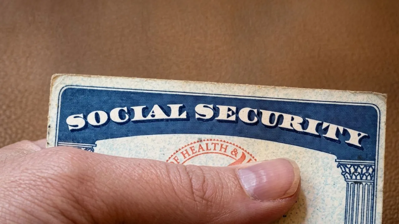 Surprised older American woman reading her phone screen showing Social Security account information after discovering changes to her benefits in 2026