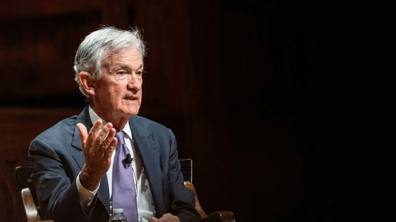 Jerome Powell seated at Federal Reserve boardroom table as governor with Fed seal visible in background