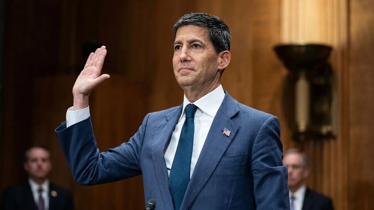 Kevin Warsh standing at a formal meeting as Federal Reserve Chair nominee awaiting Senate confirmation vote in 2026