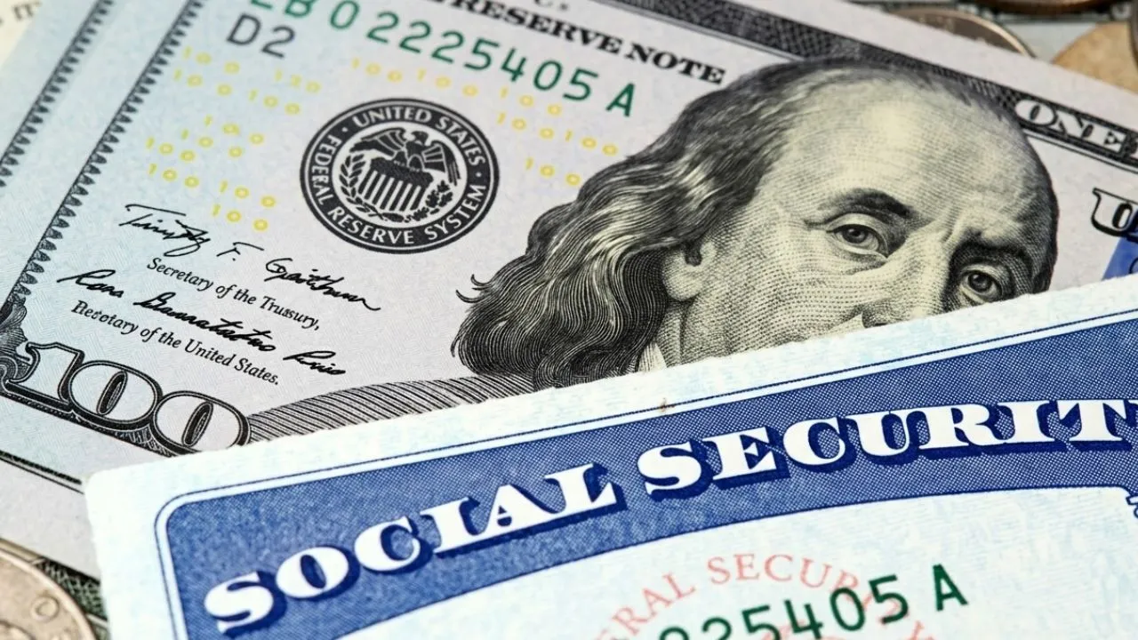 Senior woman at kitchen table reading Social Security benefit statement showing monthly payment amount in morning light