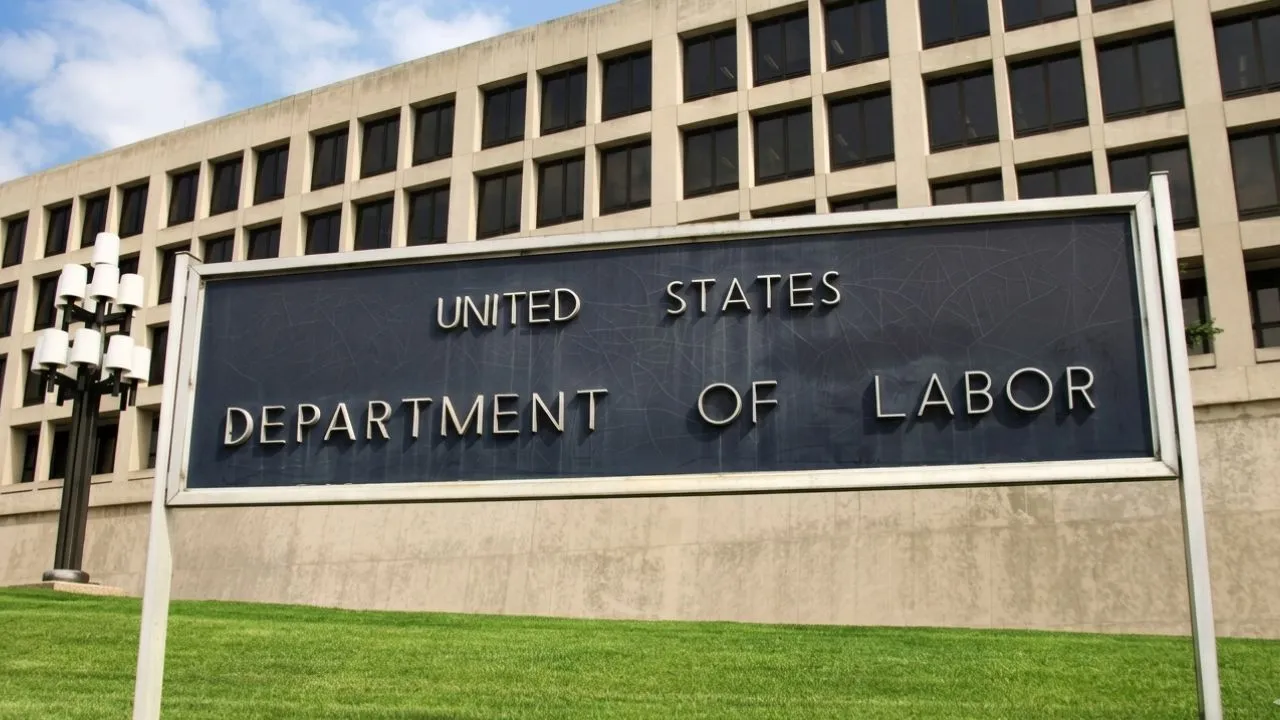 Worker reviewing 401k account as DOL proposes cryptocurrency safe harbor rule under ERISA in 2026