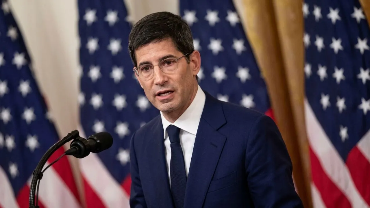 Kevin Warsh seated at the Federal Reserve boardroom table, serious expression, institutional interior visible. 1280x720 minimum. Alt text: Kevin Warsh chairs first FOMC rate decision June 17 2026 federal reserve.