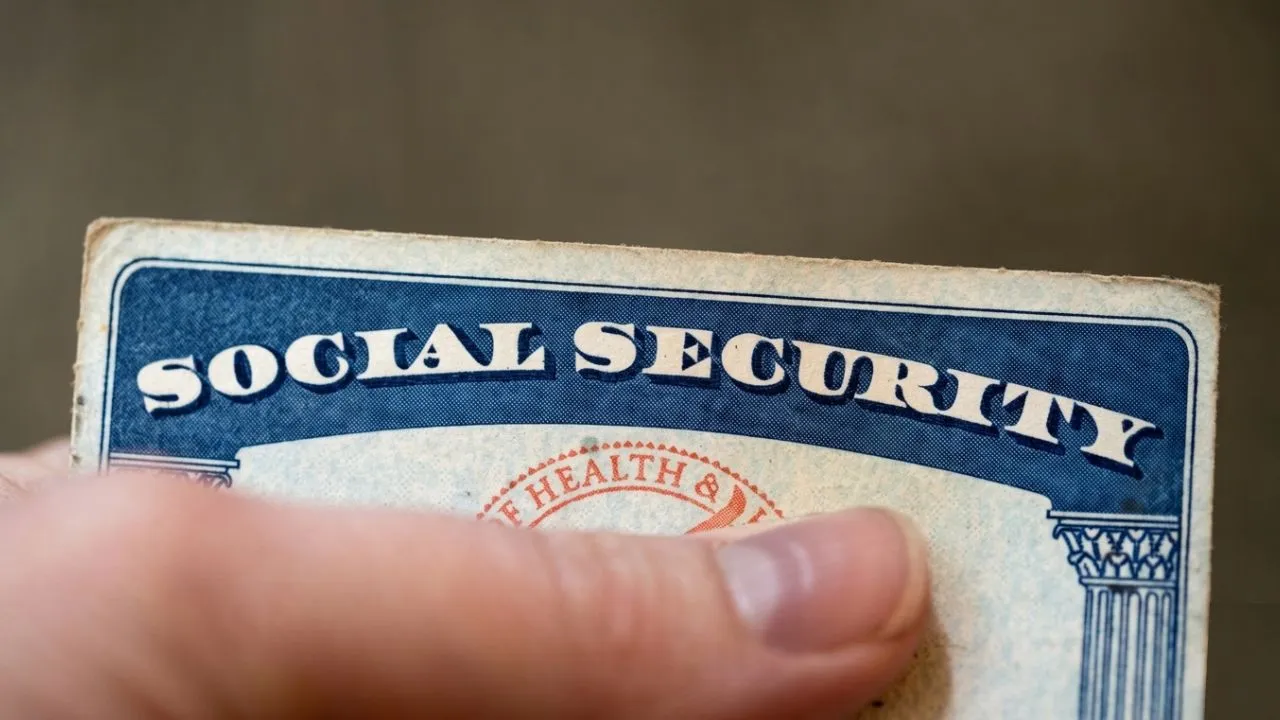 Retired couple reading Social Security letter at kitchen table as trust fund depletion projected for 2032