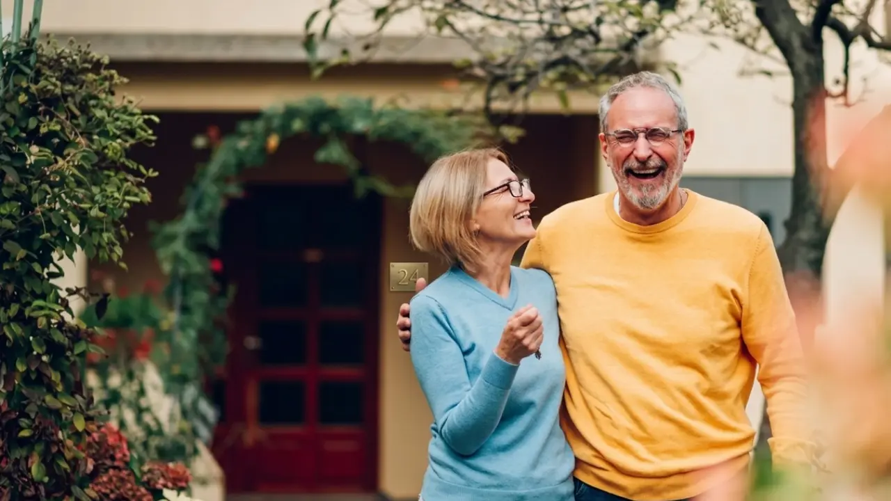Worker in their late fifties reviewing 401k statements at a home desk