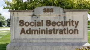 Latest U.S. Financial News and Analysis 4 Older couple reviewing Social Security paperwork and a calculator at their kitchen table