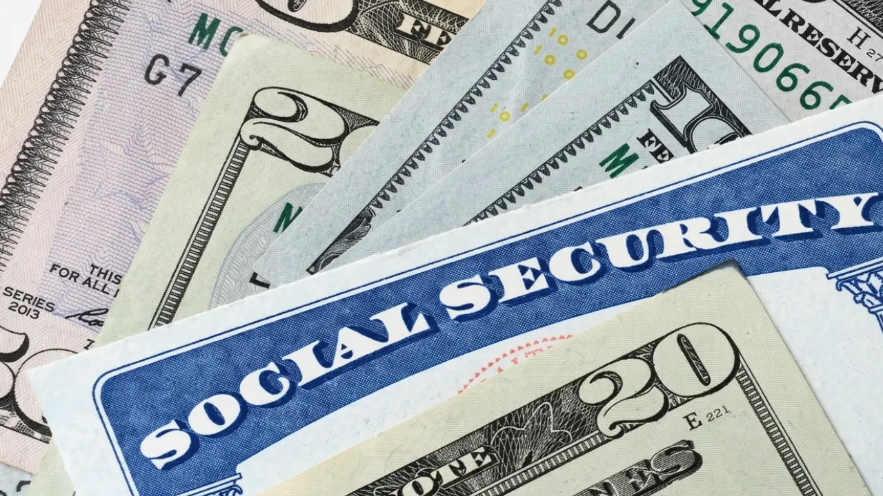 Retirement-age couple reviewing Social Security benefit paperwork at home