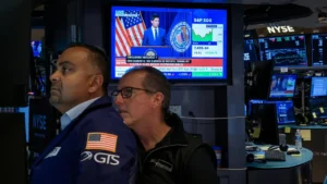 Latest U.S. Financial News and Analysis 8 NYSE traders monitor screens displaying Federal Reserve coverage, the S&P 500 and the 30-year Treasury yield.
