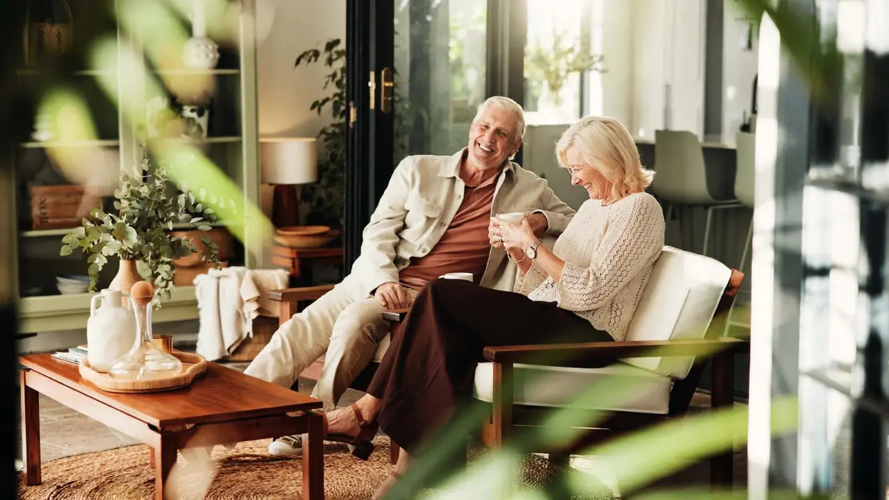 Retired couple relaxing at home, representing reliable monthly Social Security payment timing