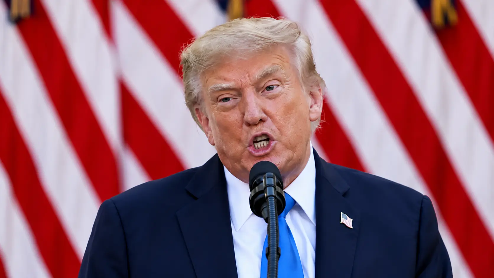 Donald Trump speaks at a podium as he calls for the Federal Reserve to lower interest rates