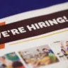 Hiring sign representing the U.S. labor market as weekly jobless claims fall to 196,000