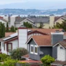 Residential homes with tiled roofs in a U.S. neighborhood, illustrating the housing market and 30-year fixed mortgage rates.