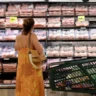 Shopper browsing refrigerated meat products at a supermarket as U.S. core PCE inflation reaches 3.1% in September 2026.
