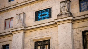 Latest U.S. Financial News and Analysis 11 Federal Reserve building exterior with stone sculptures and engraved lettering, illustrating the October 2026 Beige Book report on U.S. economic conditions.