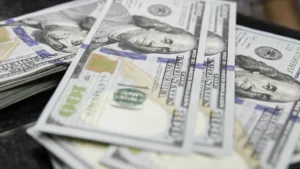 Latest U.S. Financial News and Analysis 28 Close-up of overlapping U.S. $100 bills illustrating the Federal Reserve's report on slower consumer credit growth in August 2026.