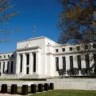 Federal Reserve headquarters building in Washington, D.C., with its main entrance and columns visible.