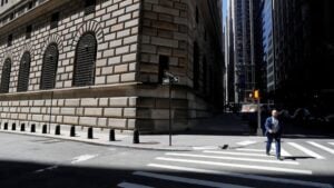 Latest U.S. Financial News and Analysis 23 A pedestrian crosses a street near the Federal Reserve Bank of New York in Manhattan's Financial District.