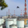 Large oil storage tanks and refinery infrastructure at an industrial petroleum facility.