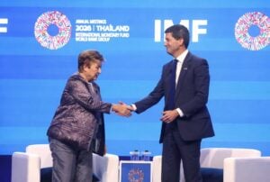 Latest U.S. Financial News and Analysis 1 Kevin Warsh and Kristalina Georgieva shake hands at the 2026 IMF Annual Meetings in Bangkok, Thailand.