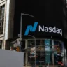 Nasdaq logo displayed on a large electronic billboard outside the Nasdaq MarketSite in Times Square, New York.