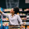 Consumer shopping in a grocery store as U.S. consumer sentiment falls to 46.3 in October 2026.