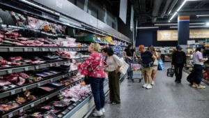 Latest U.S. Financial News and Analysis 12 Shoppers browse refrigerated meat products at a U.S. supermarket as rising consumer prices put pressure on purchasing power.